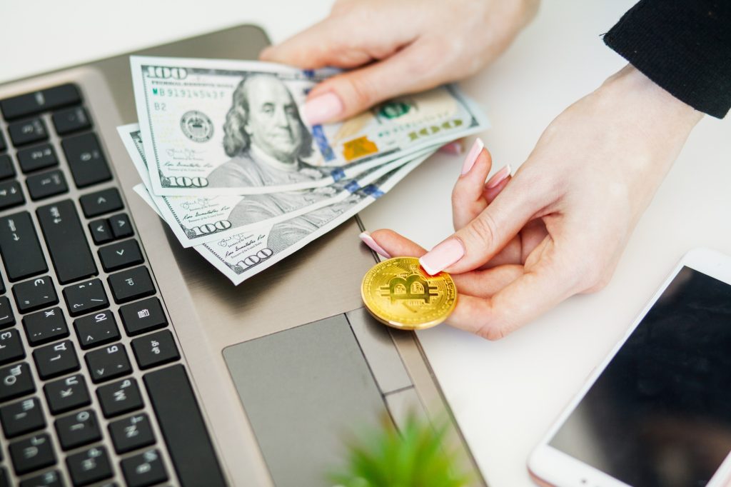 Close-up woman buying online with cryptocurrency concept, woman holding golden crypto coin